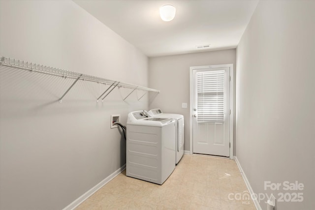 laundry room featuring independent washer and dryer, light tile patterned flooring, laundry area, baseboards, and visible vents