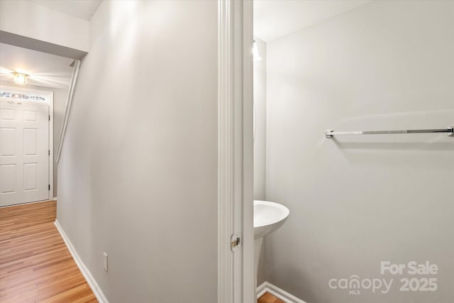 bathroom with baseboards and wood finished floors