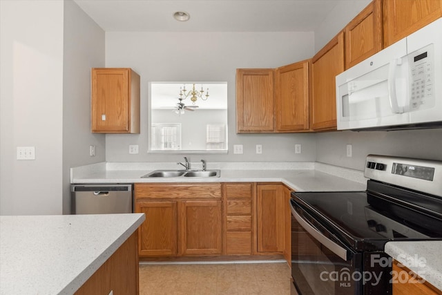 kitchen with light countertops, stainless steel appliances, brown cabinets, and a sink