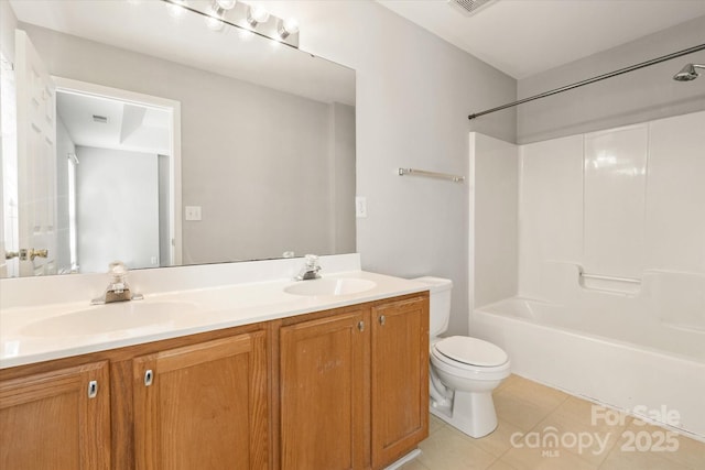 bathroom featuring a sink, tile patterned floors, toilet, and double vanity