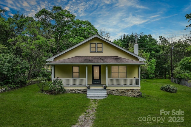 443 Ox Creek Rd, Weaverville, NC 28787 - view of front of house featuring a porch, a front lawn, roof with shingles, a chimney, and stucco siding