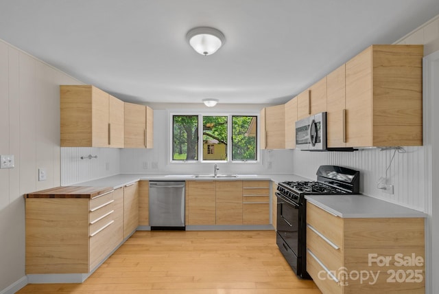 443 Ox Creek Rd, Weaverville, NC 28787 - kitchen with stainless steel appliances, light brown cabinetry, light wood-style floors, and a sink