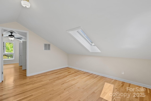 443 Ox Creek Rd, Weaverville, NC 28787 - additional living space with a skylight, vaulted ceiling, light wood-type flooring, and baseboards