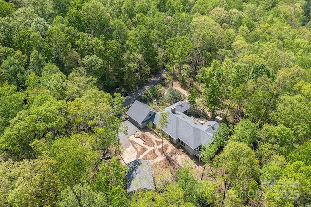 drone / aerial view featuring a wooded view