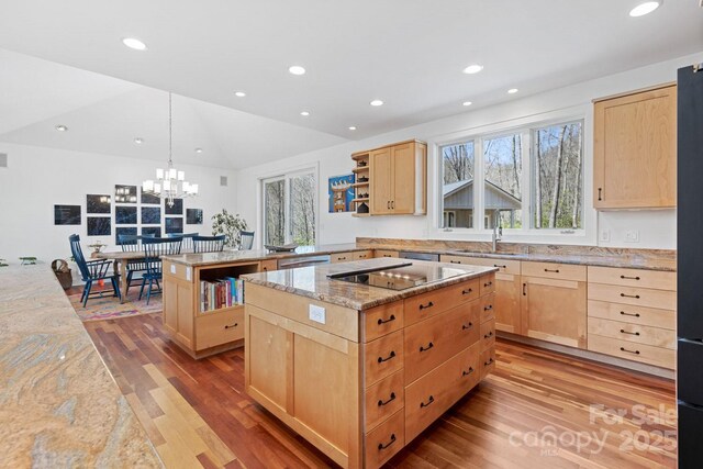 kitchen featuring black electric cooktop, open shelves, light wood-style floors, and light brown cabinets