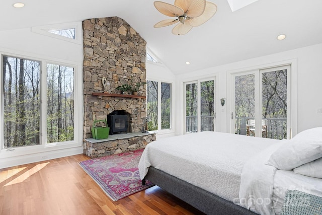 bedroom with ceiling fan, access to exterior, wood finished floors, high vaulted ceiling, and recessed lighting