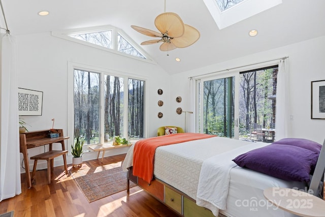 bedroom with a skylight, multiple windows, and wood finished floors