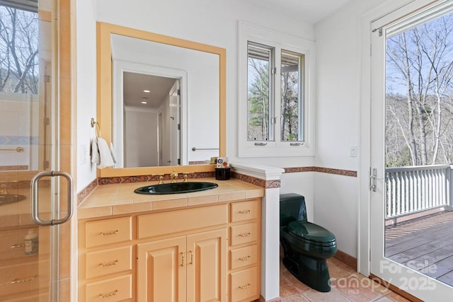 full bath featuring vanity, tile patterned flooring, a shower stall, and toilet