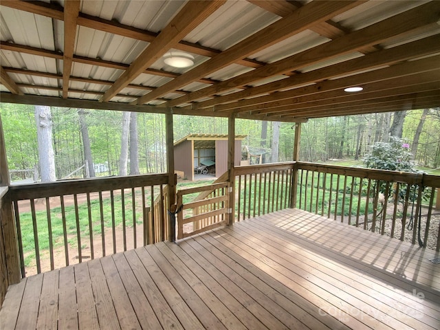wooden deck with a shed and an outbuilding