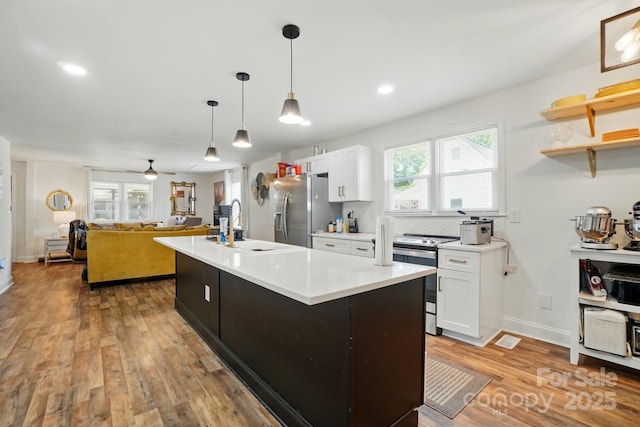 139 5th St, Huntersville, NC 28078 - kitchen with appliances with stainless steel finishes, white cabinets, light countertops, wood finished floors, and a sink