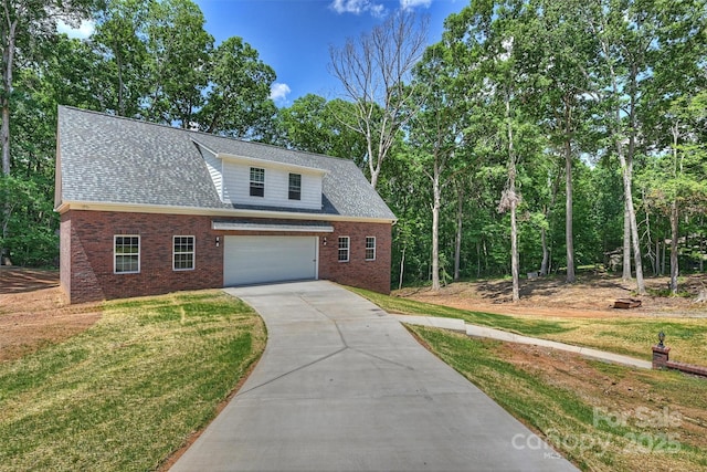 3009 Brooks Mill Ln, Wingate, NC 28174 - view of front of house with concrete driveway, brick siding, a front yard, and roof with shingles