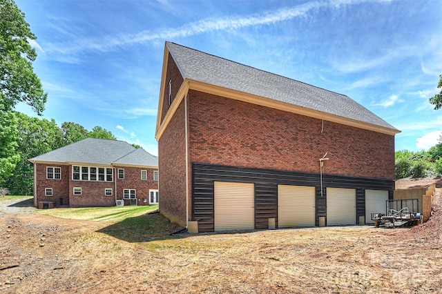 3009 Brooks Mill Ln, Wingate, NC 28174 - view of side of home featuring brick siding and roof with shingles