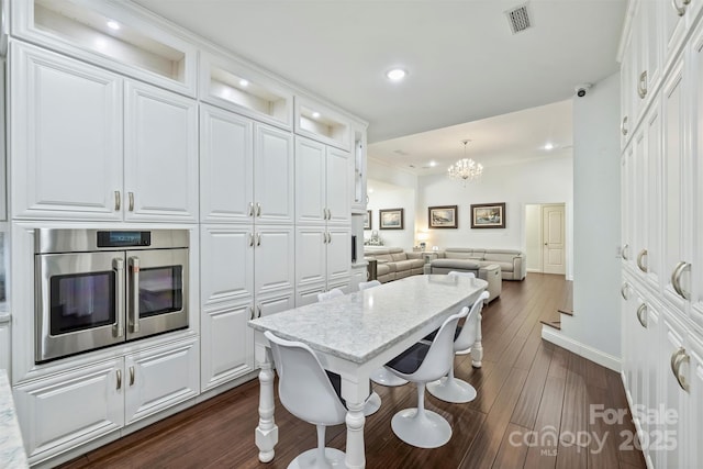 3009 Brooks Mill Ln, Wingate, NC 28174 - kitchen featuring open floor plan, white cabinetry, baseboards, dark wood-style floors, and stainless steel oven