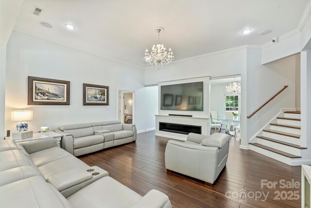 3009 Brooks Mill Ln, Wingate, NC 28174 - living room featuring a chandelier, dark wood-style flooring, stairway, baseboards, and ornamental molding