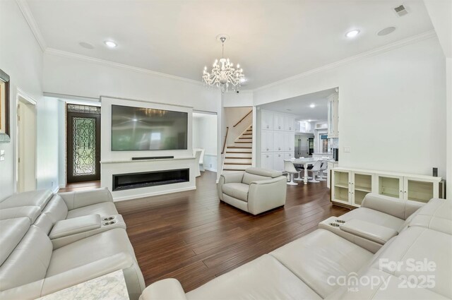 3009 Brooks Mill Ln, Wingate, NC 28174 - living area with a chandelier, dark wood-type flooring, stairs, ornamental molding, and a fireplace