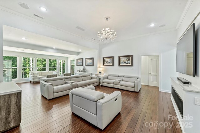 3009 Brooks Mill Ln, Wingate, NC 28174 - living room featuring ornamental molding, a chandelier, recessed lighting, and dark wood-style flooring