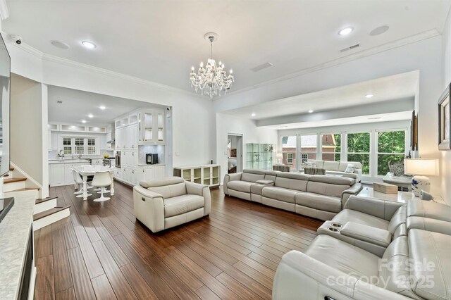 3009 Brooks Mill Ln, Wingate, NC 28174 - living room featuring crown molding, a chandelier, stairs, dark wood finished floors, and recessed lighting