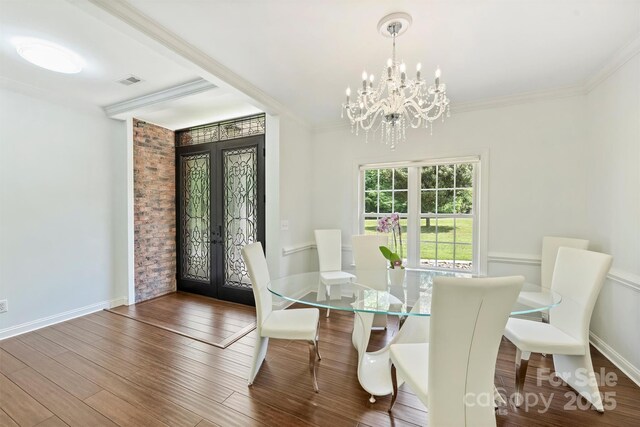 3009 Brooks Mill Ln, Wingate, NC 28174 - dining area featuring french doors, a chandelier, crown molding, wood finished floors, and baseboards