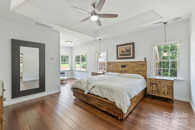 3009 Brooks Mill Ln, Wingate, NC 28174 - bedroom with a raised ceiling, dark wood-style floors, baseboards, and ceiling fan