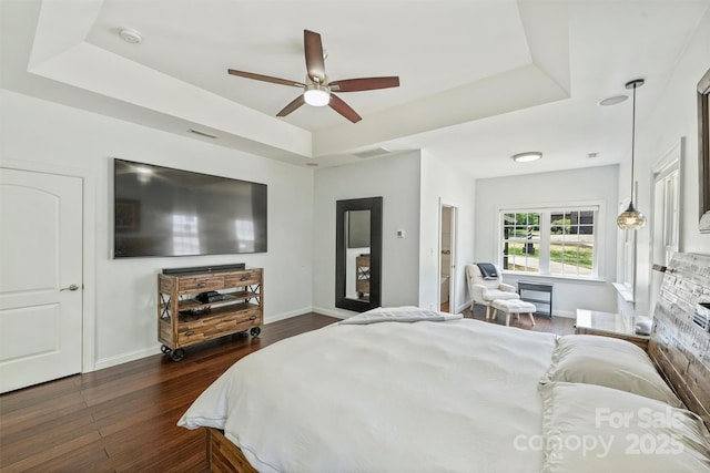 3009 Brooks Mill Ln, Wingate, NC 28174 - bedroom with a raised ceiling, dark wood-style floors, baseboards, and a ceiling fan