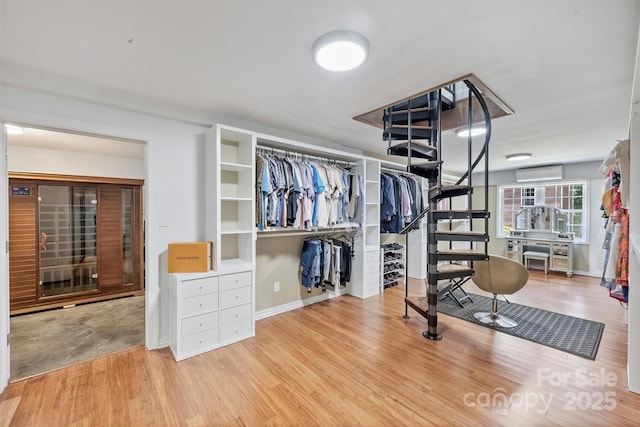 3009 Brooks Mill Ln, Wingate, NC 28174 - walk in closet with a wall mounted AC and wood finished floors