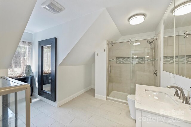 3009 Brooks Mill Ln, Wingate, NC 28174 - bathroom with a stall shower, vanity, tile patterned flooring, baseboards, and toilet