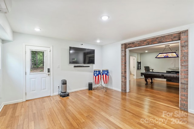 3009 Brooks Mill Ln, Wingate, NC 28174 - living room featuring wood finished floors, baseboards, a wall mounted AC, and recessed lighting