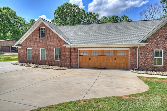 3009 Brooks Mill Ln, Wingate, NC 28174 - view of front of property with concrete driveway, a garage, brick siding, and roof with shingles