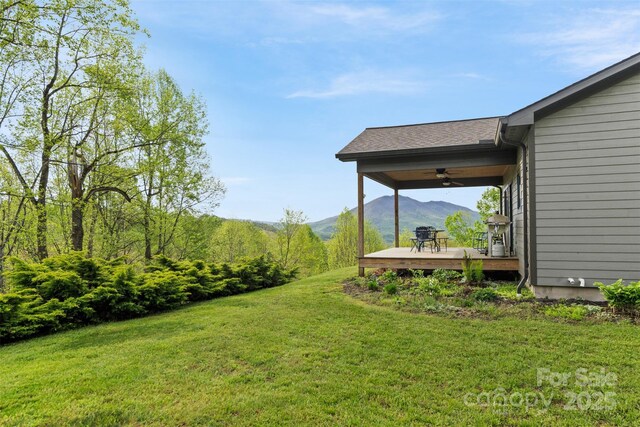 630 Graybeal Holw, Creston, NC 28615 - view of grassy yard featuring ceiling fan and a deck with mountain view