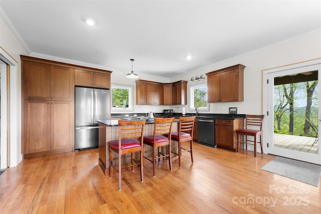 630 Graybeal Holw, Creston, NC 28615 - kitchen featuring freestanding refrigerator, black dishwasher, dark countertops, ornamental molding, and a breakfast bar