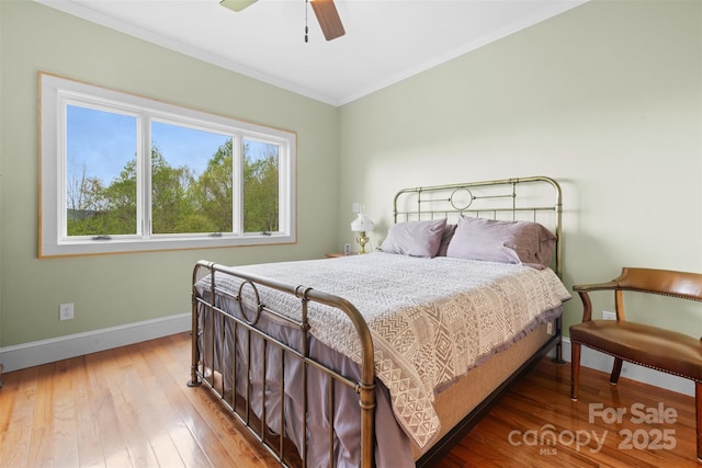 630 Graybeal Holw, Creston, NC 28615 - bedroom with baseboards, wood-type flooring, ornamental molding, and a ceiling fan