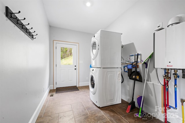 630 Graybeal Holw, Creston, NC 28615 - laundry room featuring stacked washing machine and dryer, baseboards, and tankless water heater