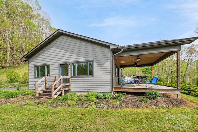630 Graybeal Holw, Creston, NC 28615 - back of house with ceiling fan, a lawn, and a wooden deck