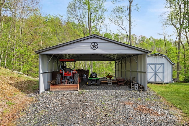 630 Graybeal Holw, Creston, NC 28615 - view of shed with a detached carport, gravel driveway, and a forest view