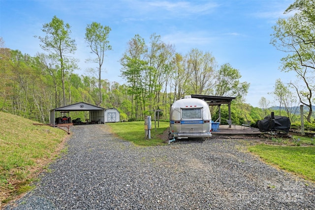 630 Graybeal Holw, Creston, NC 28615 - view of parking with a storage shed, a detached carport, and gravel driveway