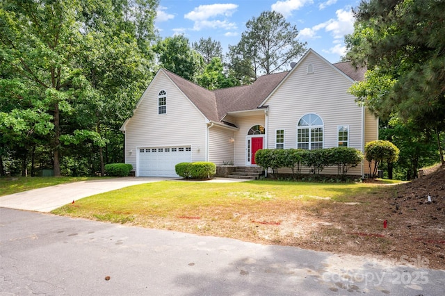 traditional home featuring a garage, roof with shingles, concrete driveway, and a front lawn