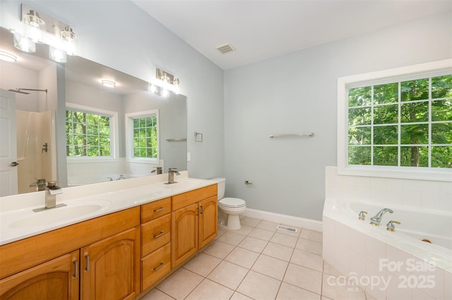 bathroom featuring a garden tub, a sink, tile patterned floors, and double vanity