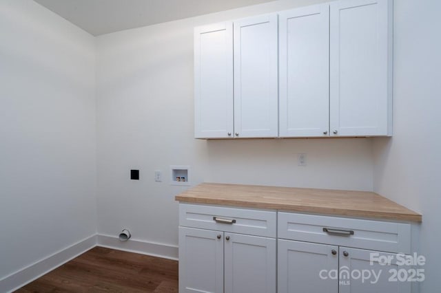 laundry area with baseboards, cabinet space, electric dryer hookup, dark wood finished floors, and washer hookup