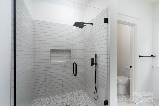full bath with toilet, baseboards, and a shower stall