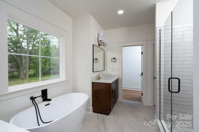 bathroom featuring a freestanding tub, a shower stall, vanity, marble finish floor, and recessed lighting