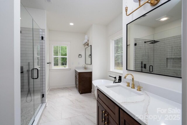 bathroom featuring a sink, marble finish floor, and a stall shower