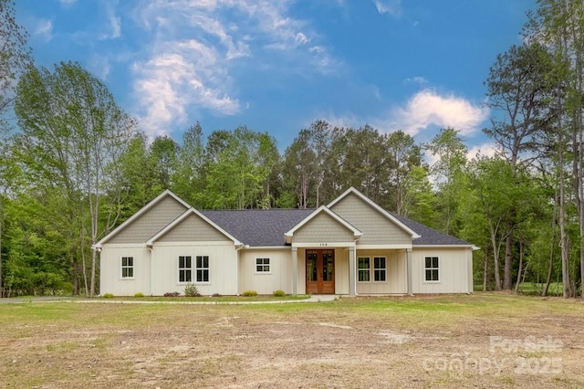 view of front of home with board and batten siding and french doors