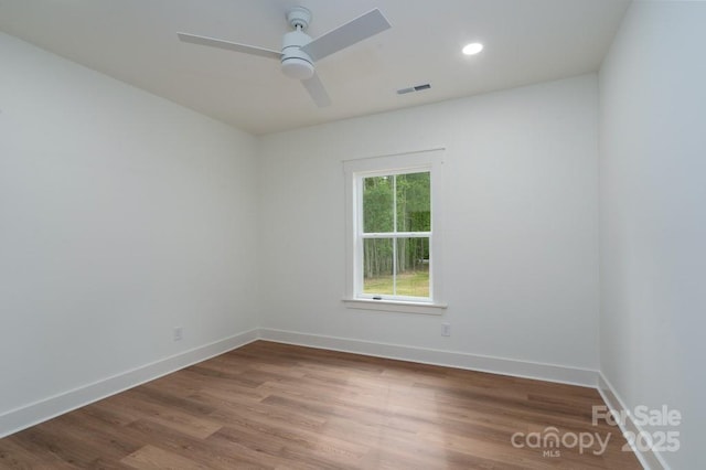 unfurnished room featuring visible vents, wood finished floors, baseboards, recessed lighting, and a ceiling fan