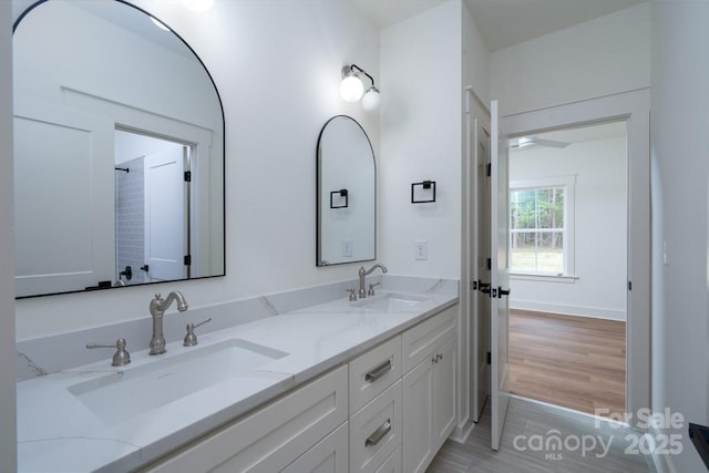 full bath with a sink and double vanity