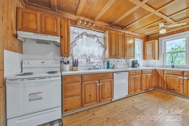 kitchen featuring a sink, white appliances, light wood-style flooring, under cabinet range hood, and wood ceiling