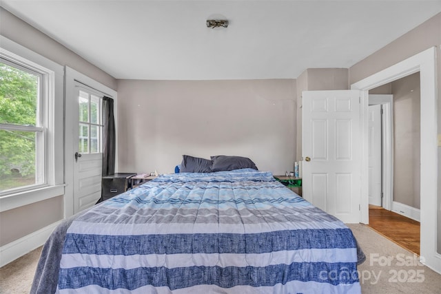 carpeted bedroom featuring baseboards