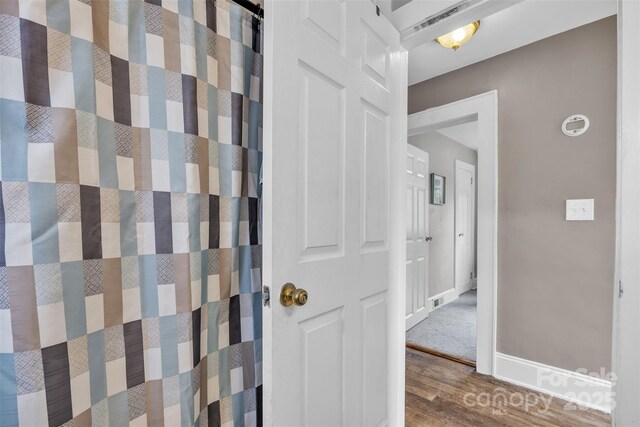 bathroom featuring baseboards and wood finished floors