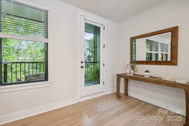 entryway featuring wood finished floors and baseboards