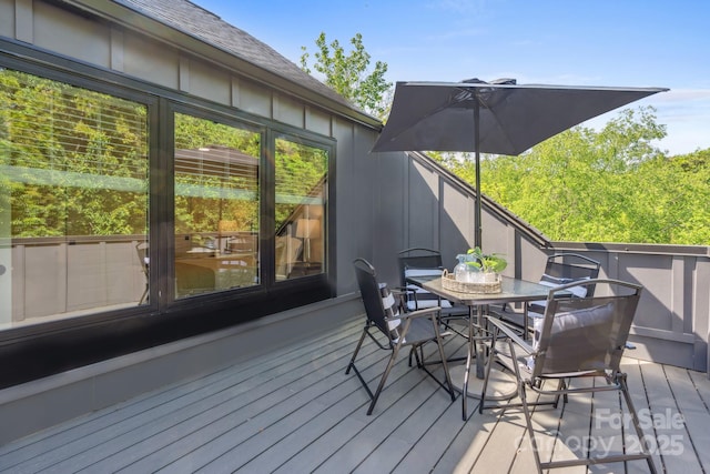 wooden terrace featuring outdoor dining area