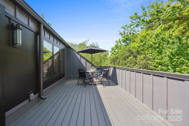 wooden deck with outdoor dining area